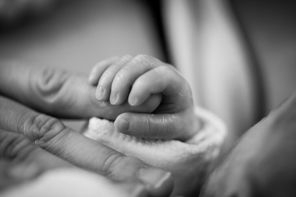 Newborn Holding Hands